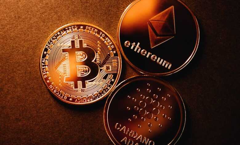 Close-up of Bitcoin, Ethereum, and Cardano coins arranged on a metallic copper background.
