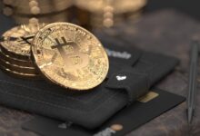 silver round coin on black leather case