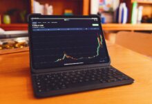 a laptop computer sitting on top of a wooden desk