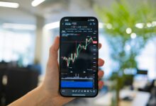 a person holding a cell phone in their hand