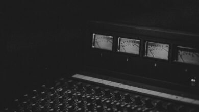 black laptop computer turned on displaying music player