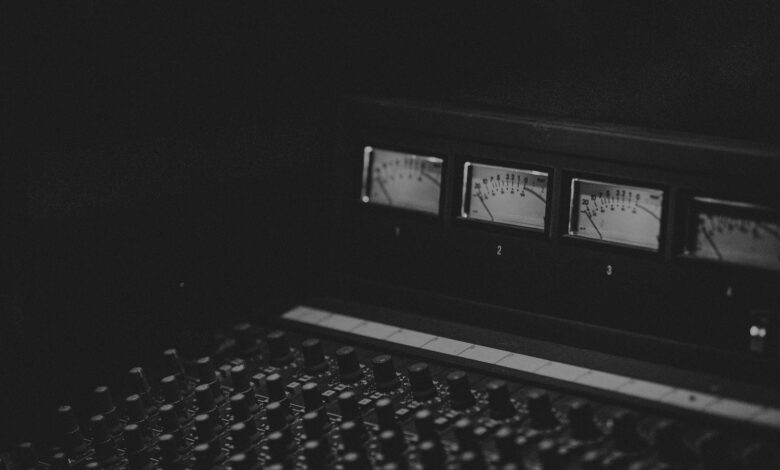 black laptop computer turned on displaying music player