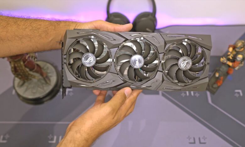 a person holding a computer fan in their hand